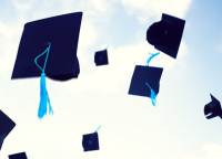 Graduation hats flying in the air