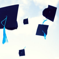 Graduation hats flying in the air