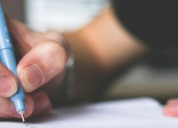 Person writing in a notebook