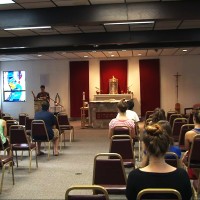 Students worshipping at the Newman Center